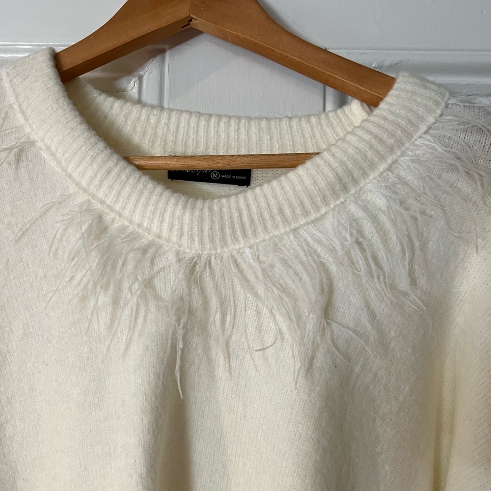 Super soft sweater with feather detailing at neck